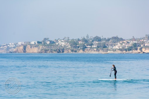 A woman using a standing on a Paddleboard on the ocean at Laguna Beach, California, USA.
