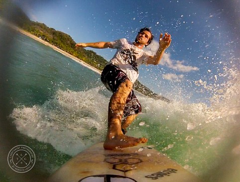 Young surfer riding a wave at Playa Jaco.